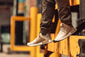 Beige trainers in front of yellow beam