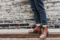 Brown leather boots on a curb